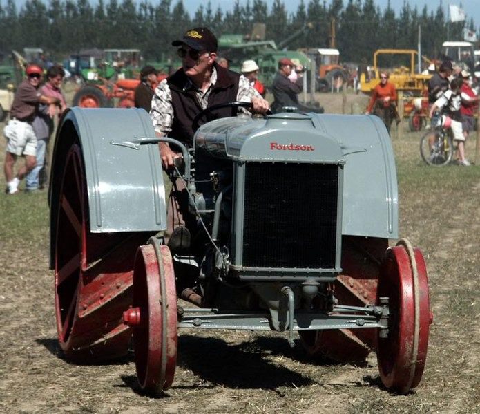 A gray and red Fordson tractor