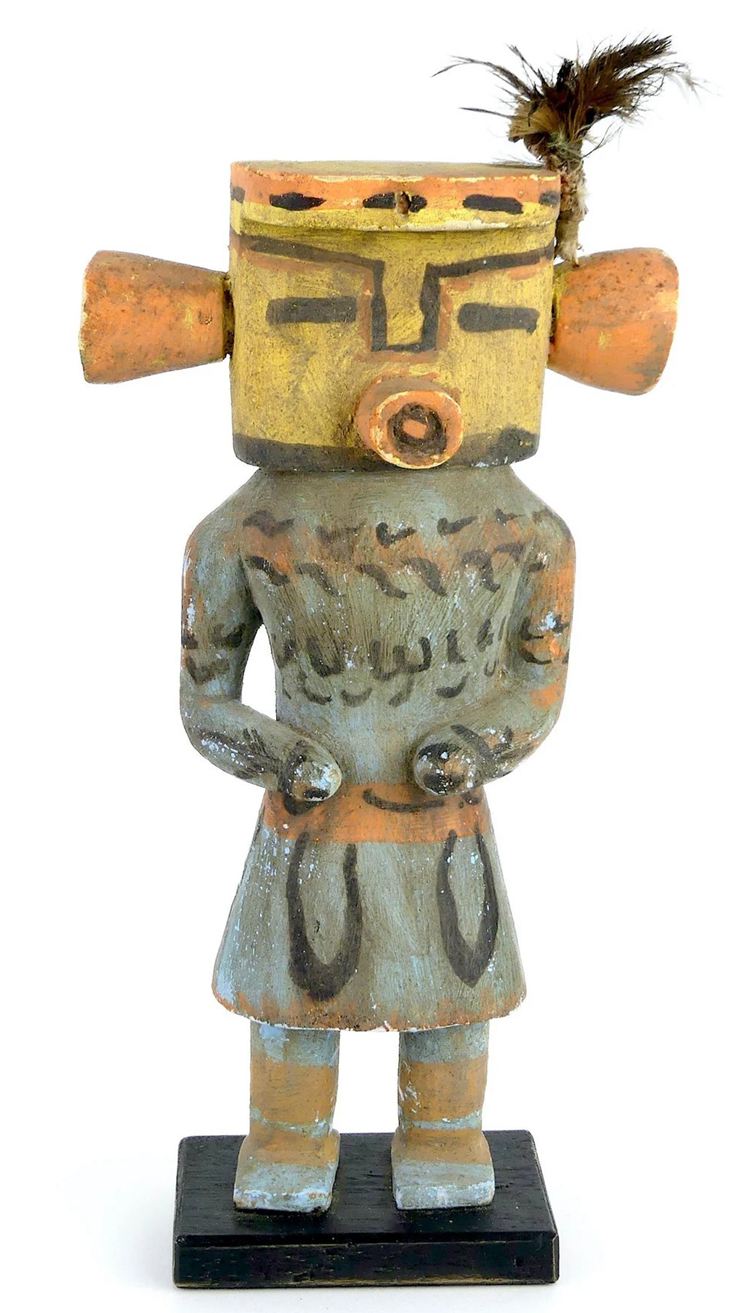 A kachina doll with painted facial features