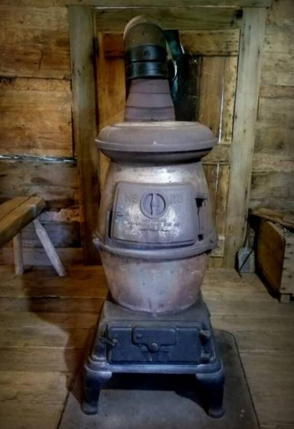 Big metal pot belly stove in Log Cabin