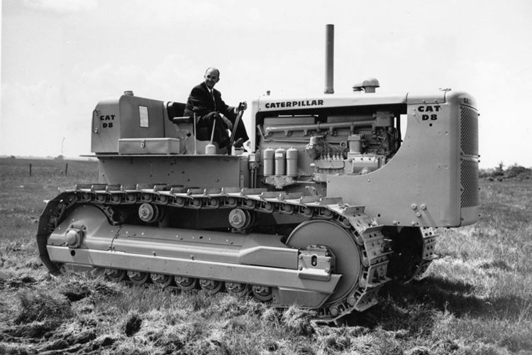 The first caterpillar tractor with a man sitting on it