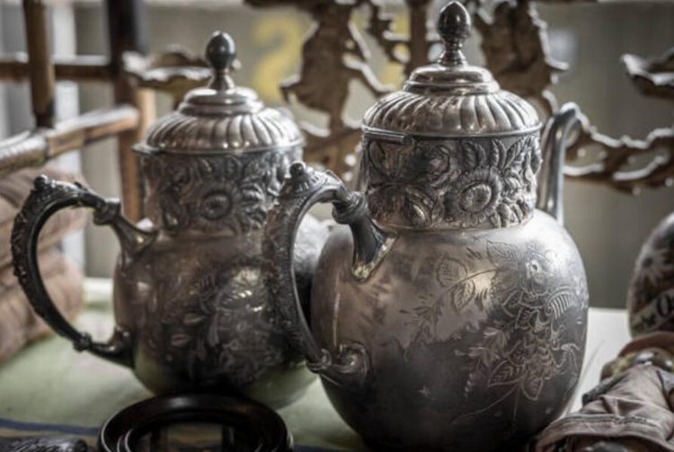 展出的两个古董银茶壶，背景模糊