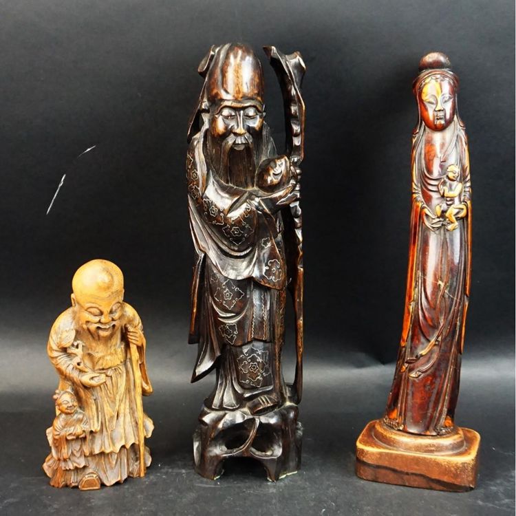 Antique Chinese Tea Stained Bone Carved Guanyin Figurine together with Two Chinese Wood Carved Buddha Figurines sold for $100