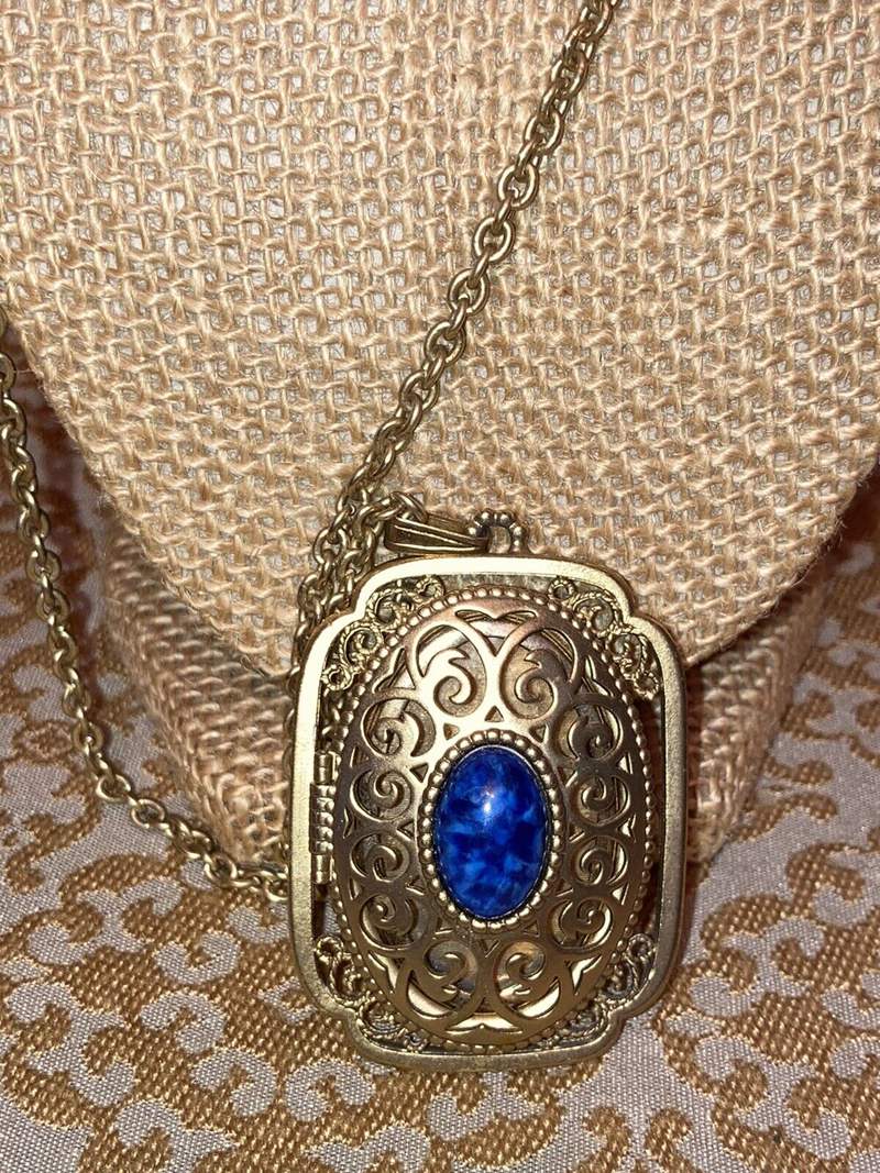 Avon Gold Tone Locket Necklace with Open Scrollwork and Faux Lapis Center stone