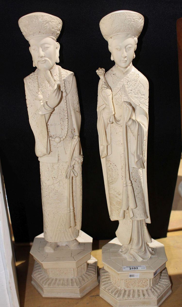 Pair of Chinese figurines - one of a lady and one of a gentleman, carved resin design sold for $238.52